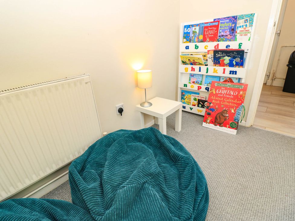 A children's room with a bookshelf and bean bag at Altair Colwell Bay near Freshwater