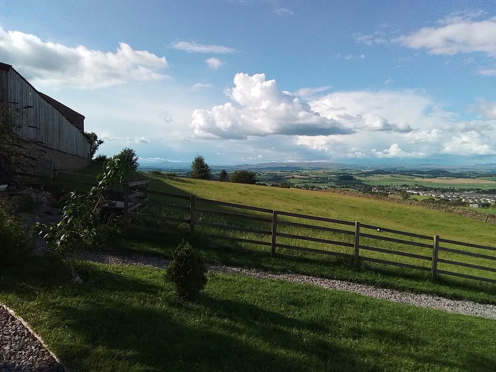 An outdoor view of a landscape with a fence and grass at The Herdsman Luxury Shepherds Hut Barnoldswick