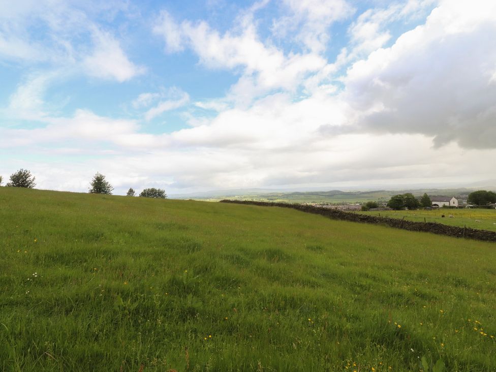A landscape with grass and trees at The Herdsman Luxury Shepherds Hut Barnoldswick
