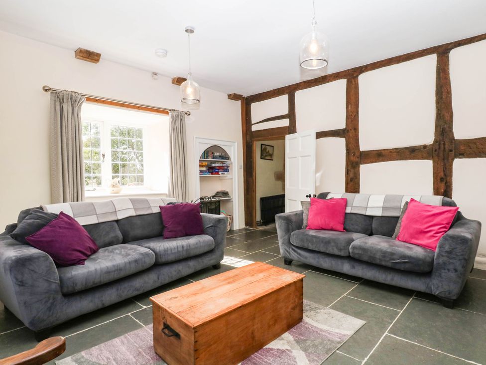 A living room with sofas and a coffee table at The Abbey Grange near Charmouth