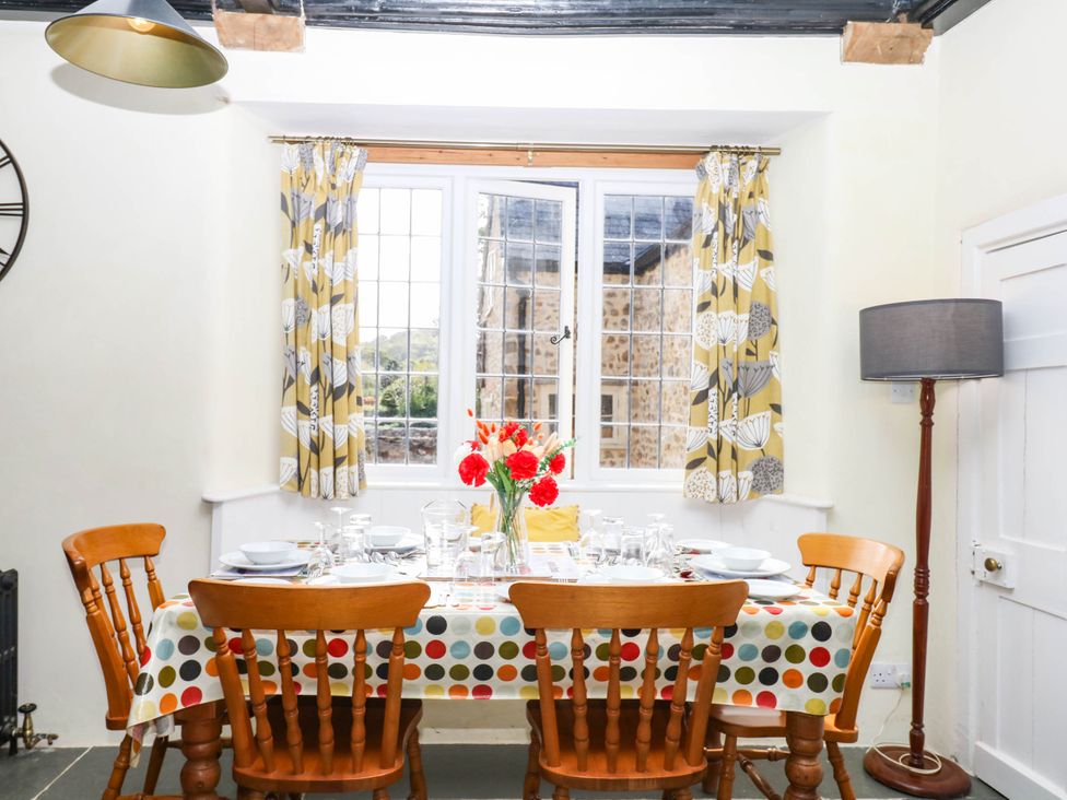 A dining room with a table set for dinner at The Abbey Grange near Charmouth