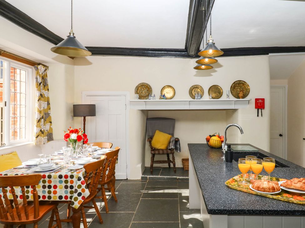 A kitchen with a dining table and chairs at The Abbey Grange near Charmouth