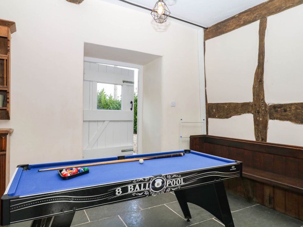 A game room with a pool table and door at The Abbey Grange near Charmouth