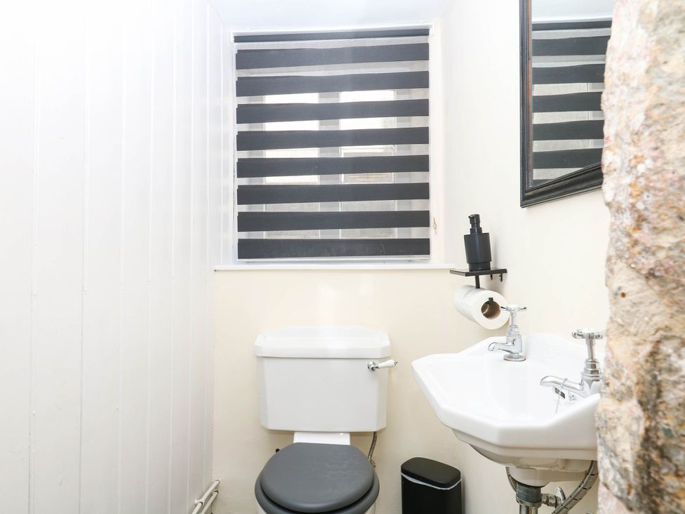 A bathroom with toilet and sink at The Abbey Grange near Charmouth