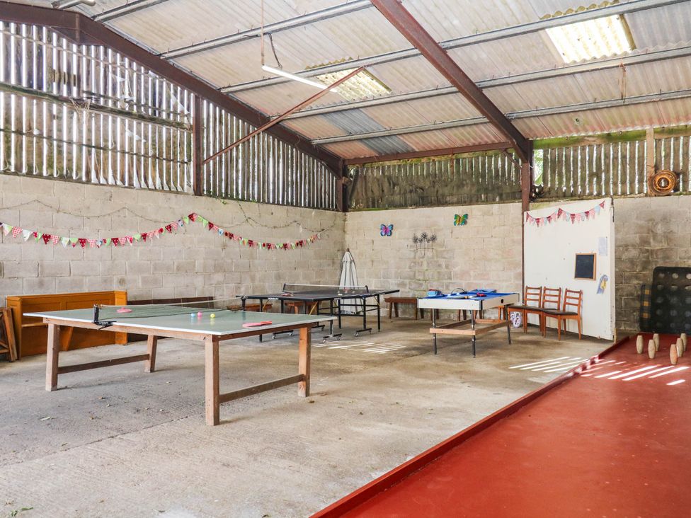 A recreation room with tables and ping pong table at The Abbey Grange near Charmouth