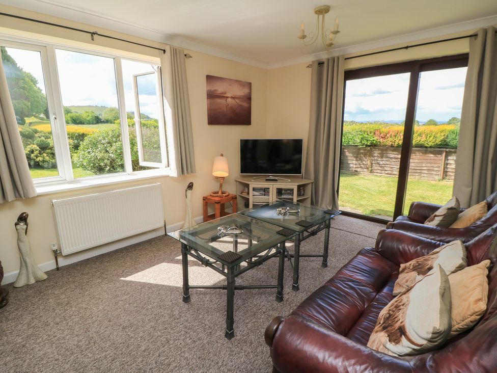 A living room with a television and sofa at Ryecross Farm Cottage in Shaftesbury
