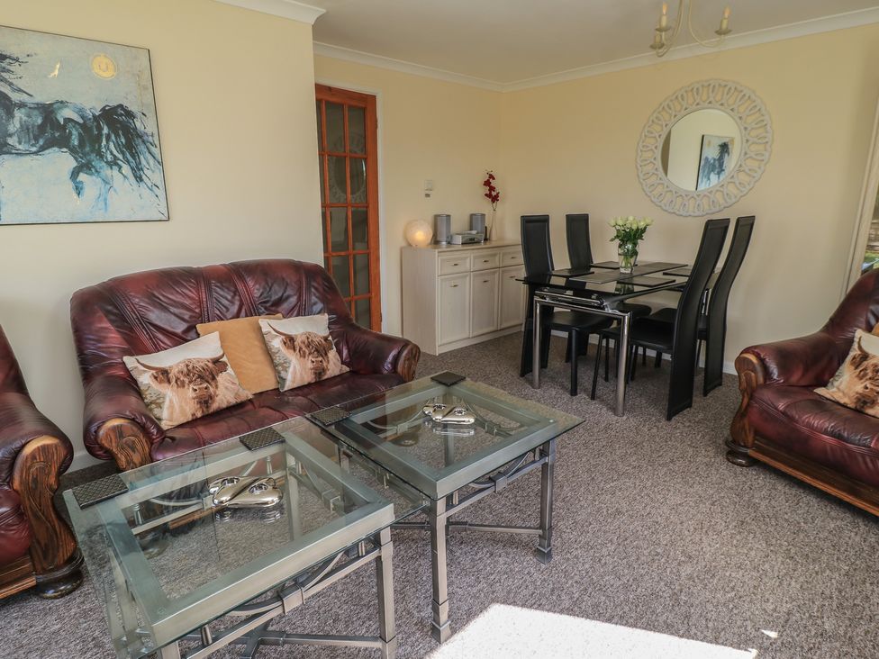 A living room with a sofa and dining area at Ryecross Farm Cottage in Shaftesbury