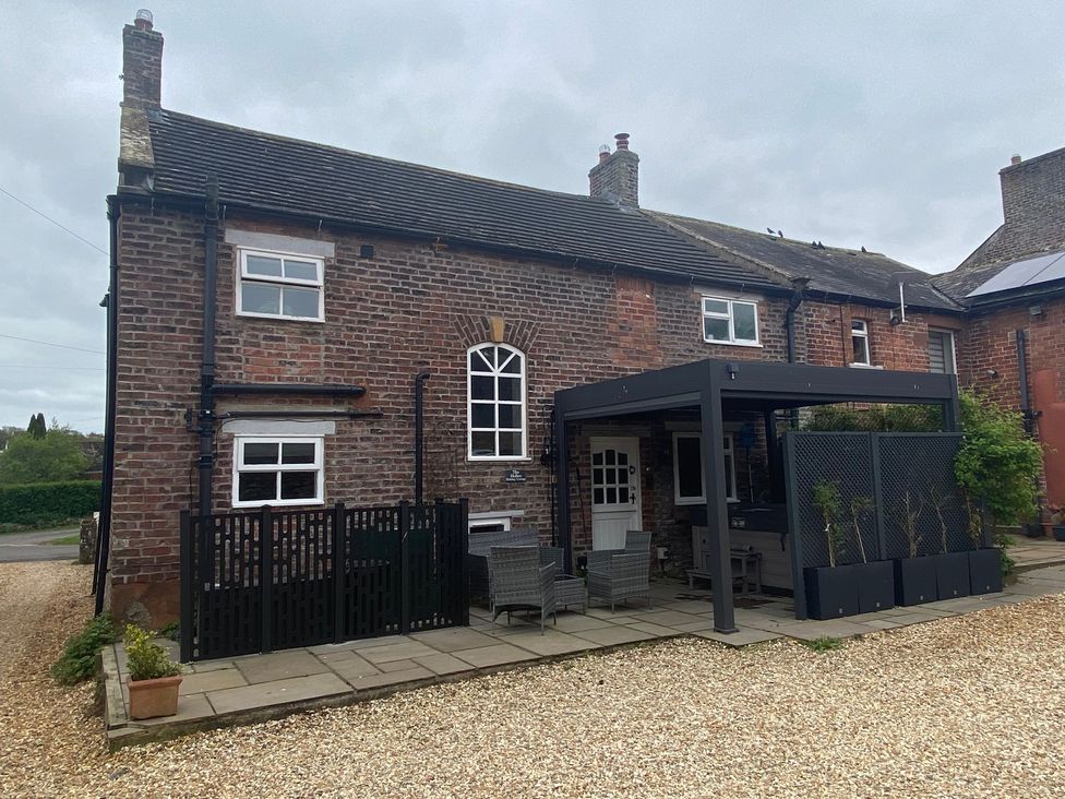 A house with a patio and seating area at The Hollies Thurstonfield near Carlisle