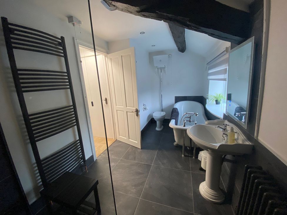 A bathroom featuring a bathtub, sink, and toilet at The Hollies, Thurstonfield near Carlisle