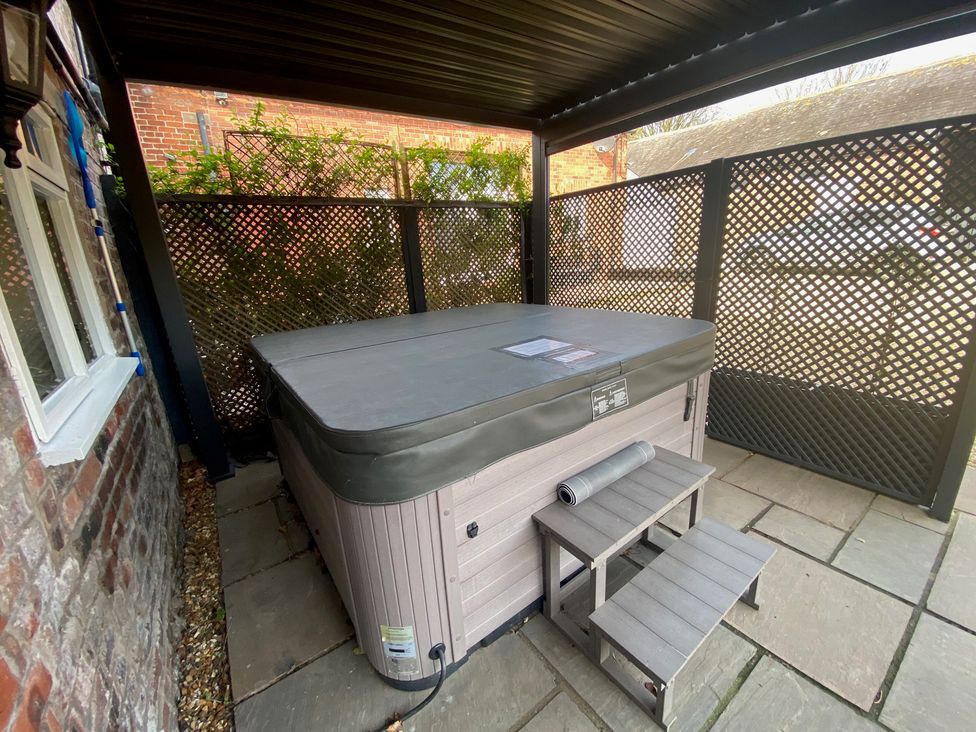 An outdoor area with a hot tub and steps at The Hollies in Thurstonfield near Carlisle
