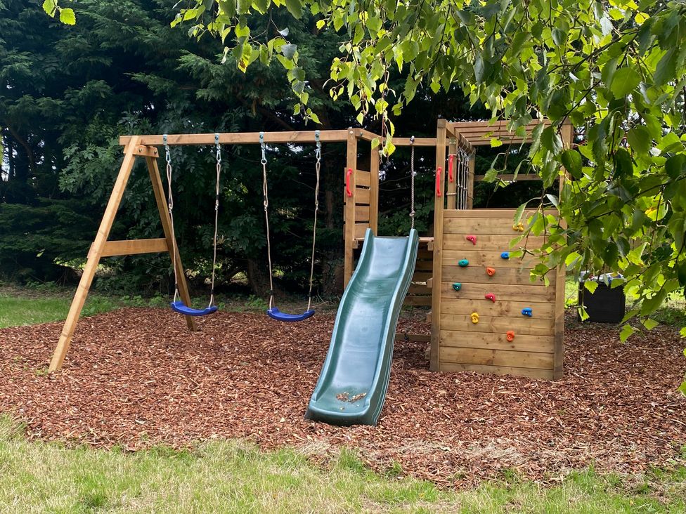A playground with swings and a slide at The Hollies near Carlisle