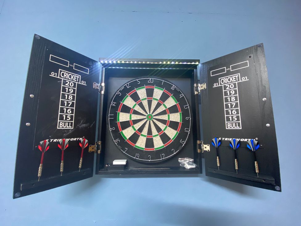 A dartboard with darts and scoreboard at The Hollies in Thurstonfield near Carlisle