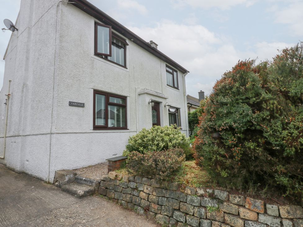 A house with bushes and a pathway at Fairfield in Llanbedrog