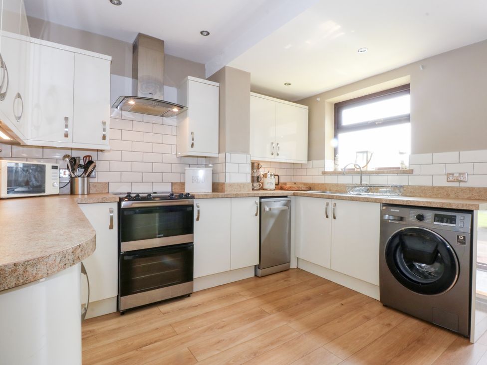 A kitchen with cabinets and appliances at Fairfield in Llanbedrog