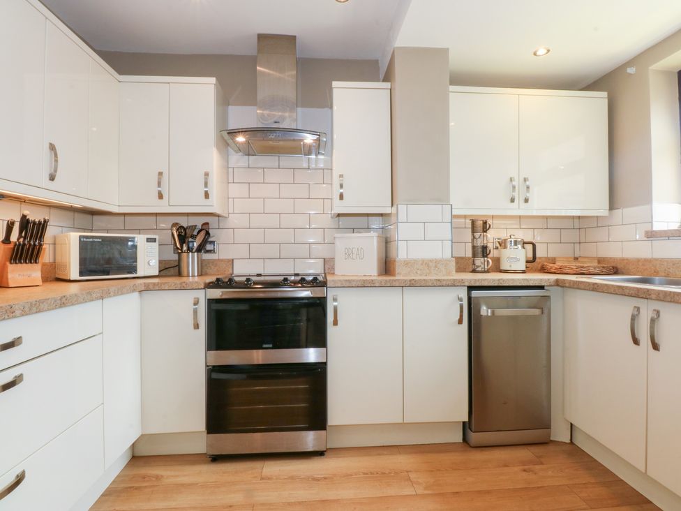 A kitchen with appliances and cabinets at Fairfield in Llanbedrog
