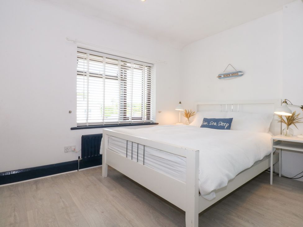 A bedroom with a bed and nightstands at Fairfield in Llanbedrog