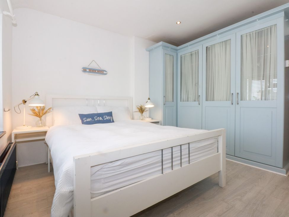 A bedroom with a bed and wardrobe at Fairfield in Llanbedrog