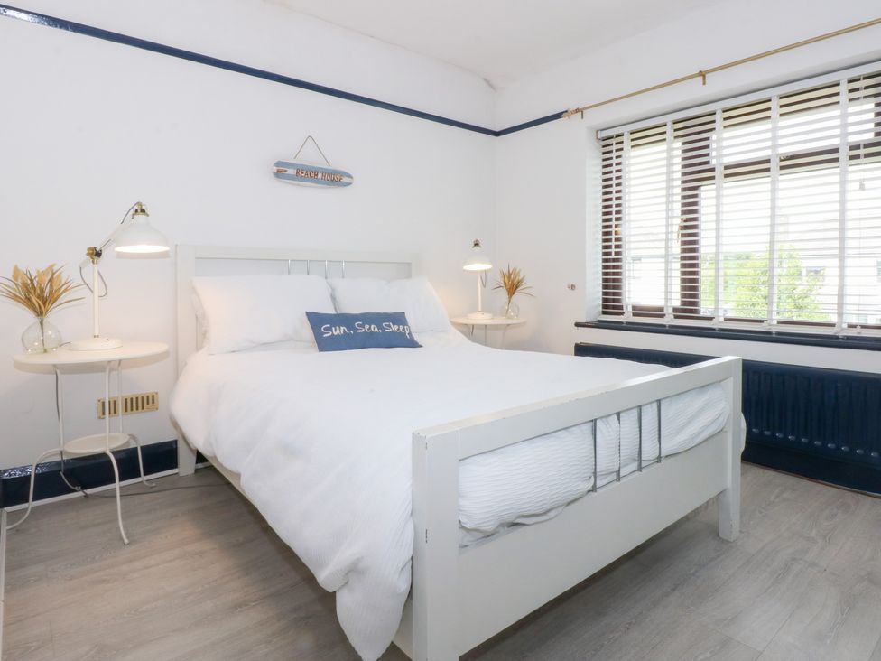 A bedroom with a bed and nightstands at Fairfield in Llanbedrog