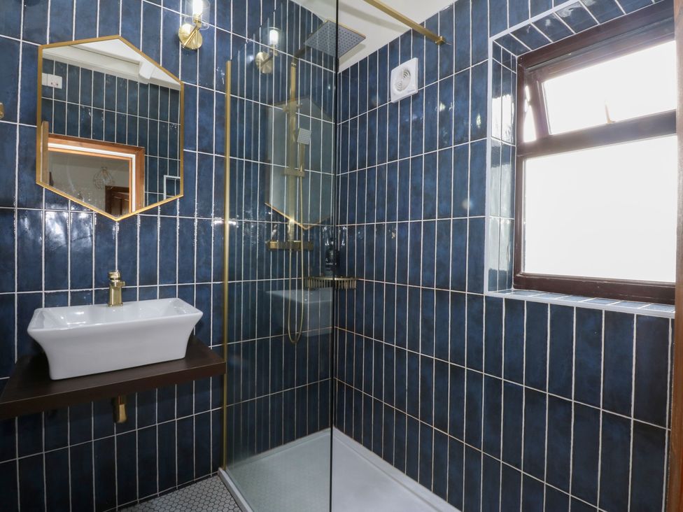 A bathroom with a sink and shower at Fairfield in Llanbedrog