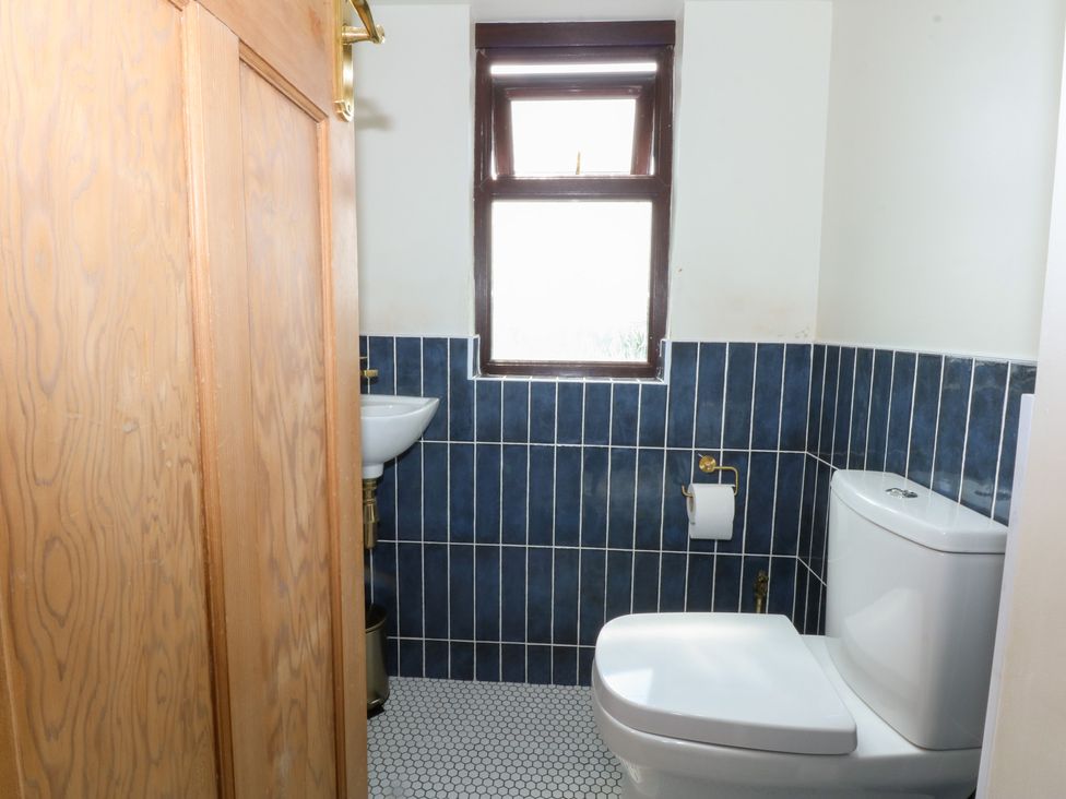 A bathroom with a toilet and sink at Fairfield in Llanbedrog