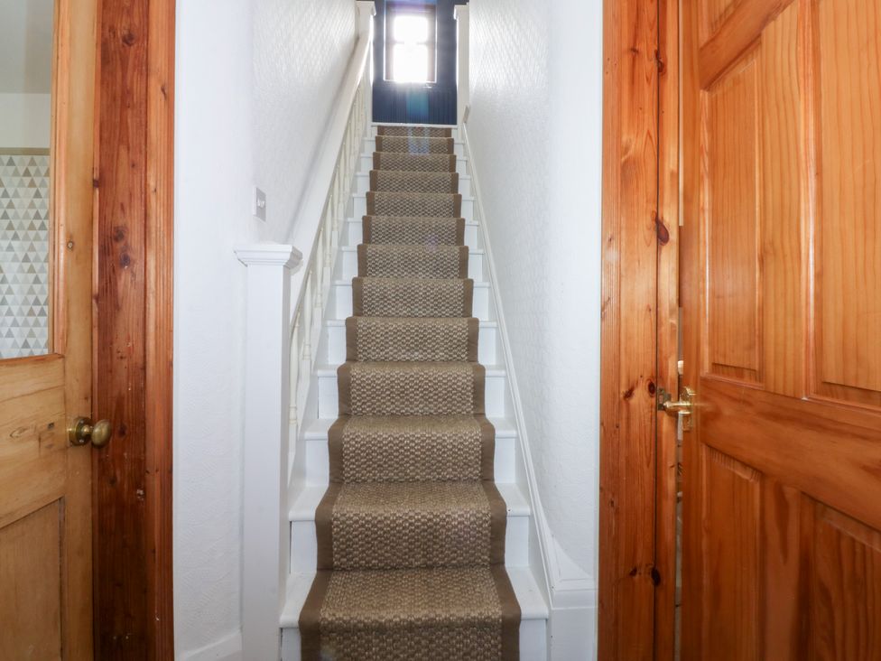 A staircase in a hallway at Fairfield in Llanbedrog