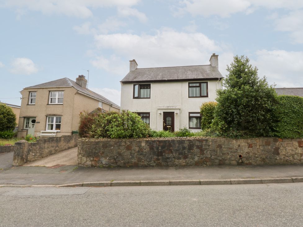A house with a front garden and a wall at Fairfield in Llanbedrog