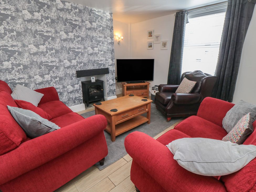 A living room with a sofa and coffee table at Bluebell Cottage in Flamborough