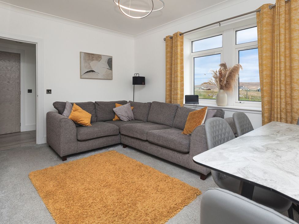 A living room with a sofa and table at Dun Buidhe near Daliburgh, Isle Of South Uist