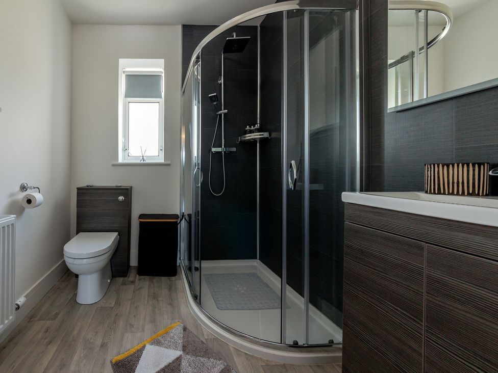 A bathroom with a shower and toilet at Dun Buidhe South Boisdale near Daliburgh Isle Of South Uist