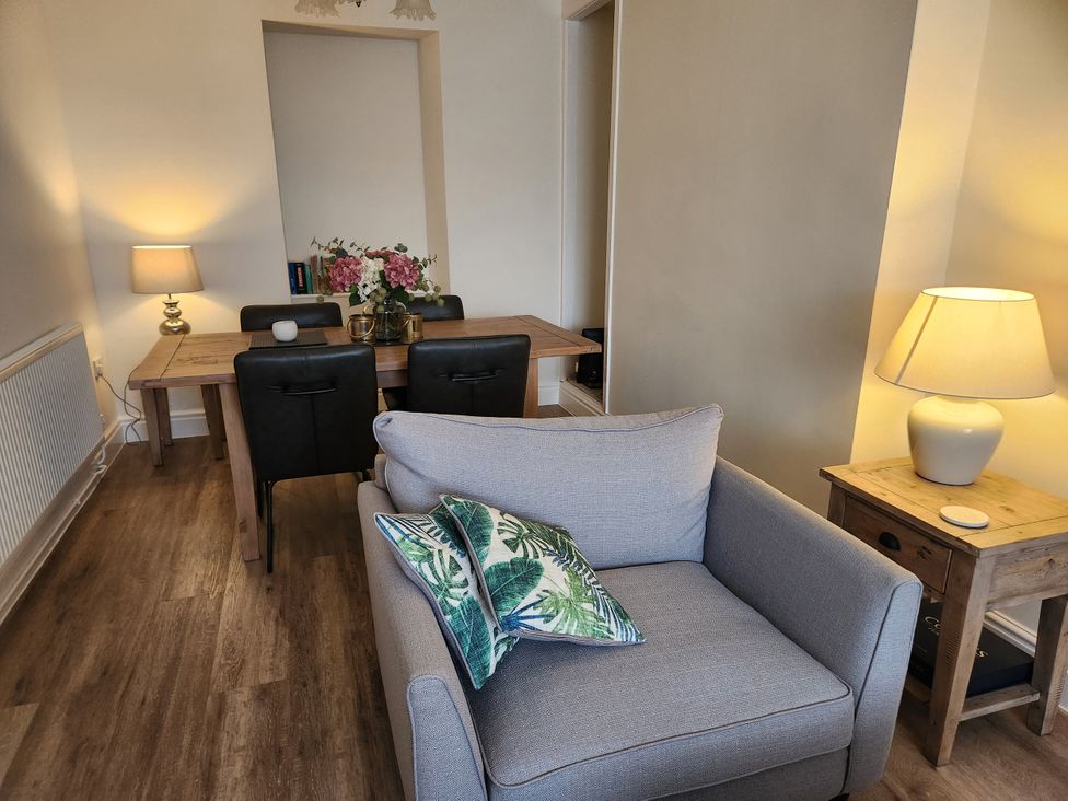 A dining room with a table and chairs at 8 Arvonia Terrace Cricieth