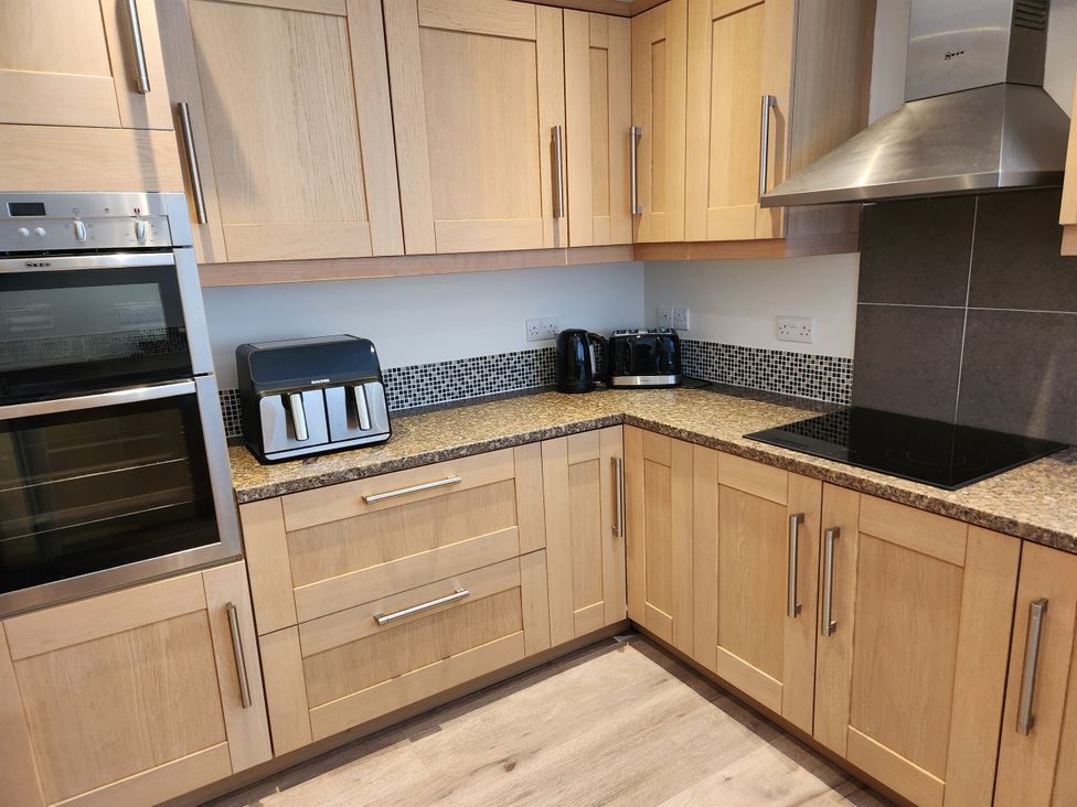 A kitchen with oven and countertop appliances at 8 Arvonia Terrace Cricieth