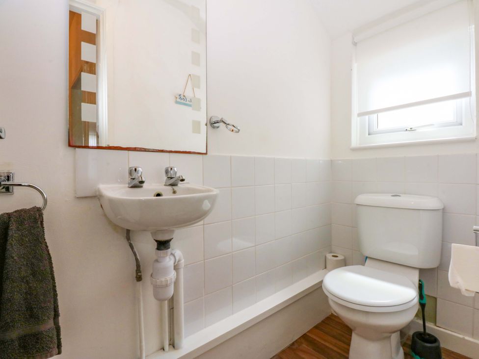 A bathroom with a sink and toilet at Y Berth in Caernarfon