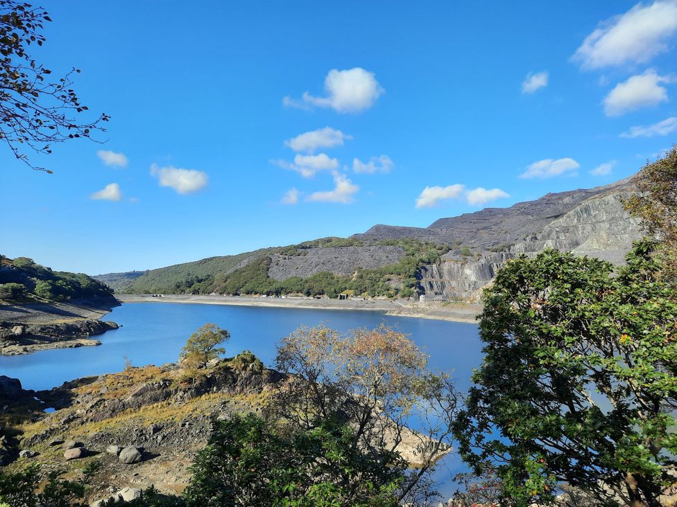 A lake surrounded by mountains and trees at Y Berth Caernarfon