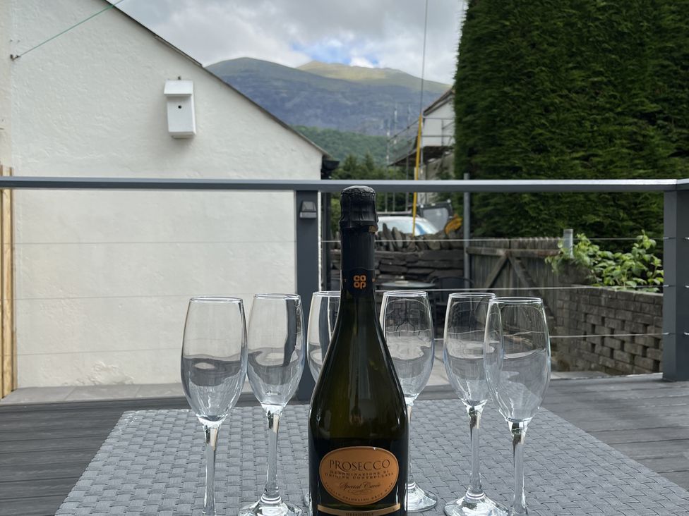 An outdoor table with Prosecco and glasses at Y Berth in Llanberis