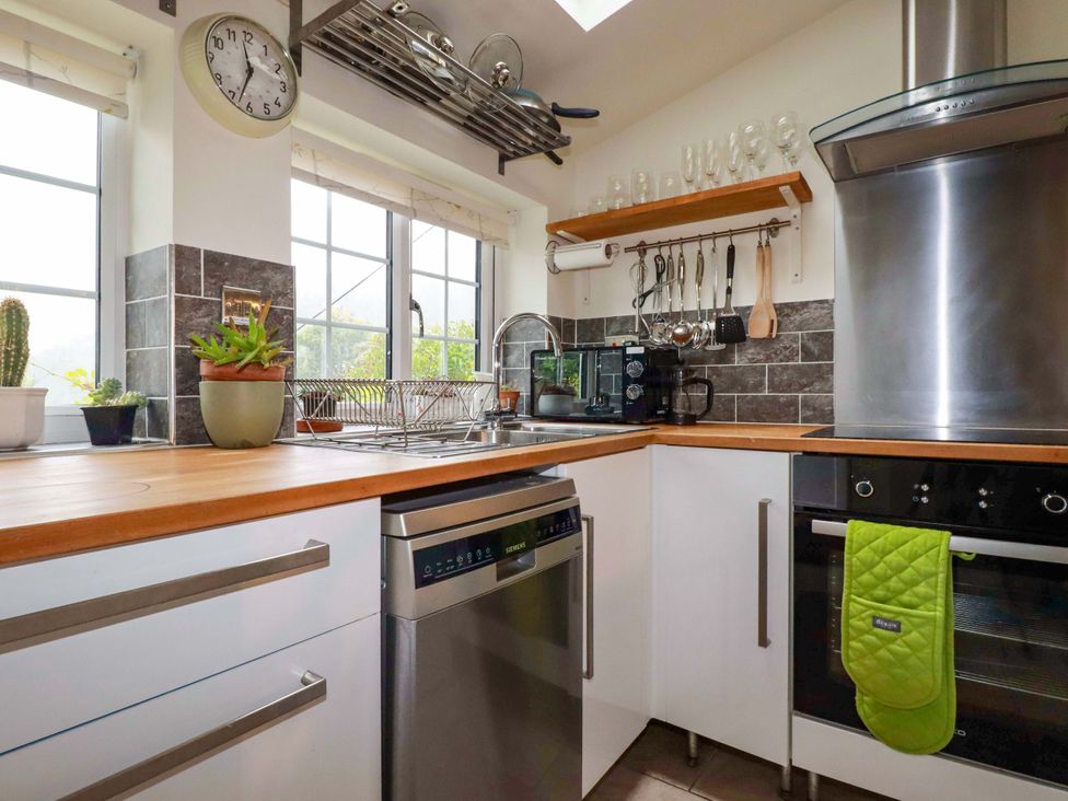 A kitchen with a sink and appliances at Woodview in Looe