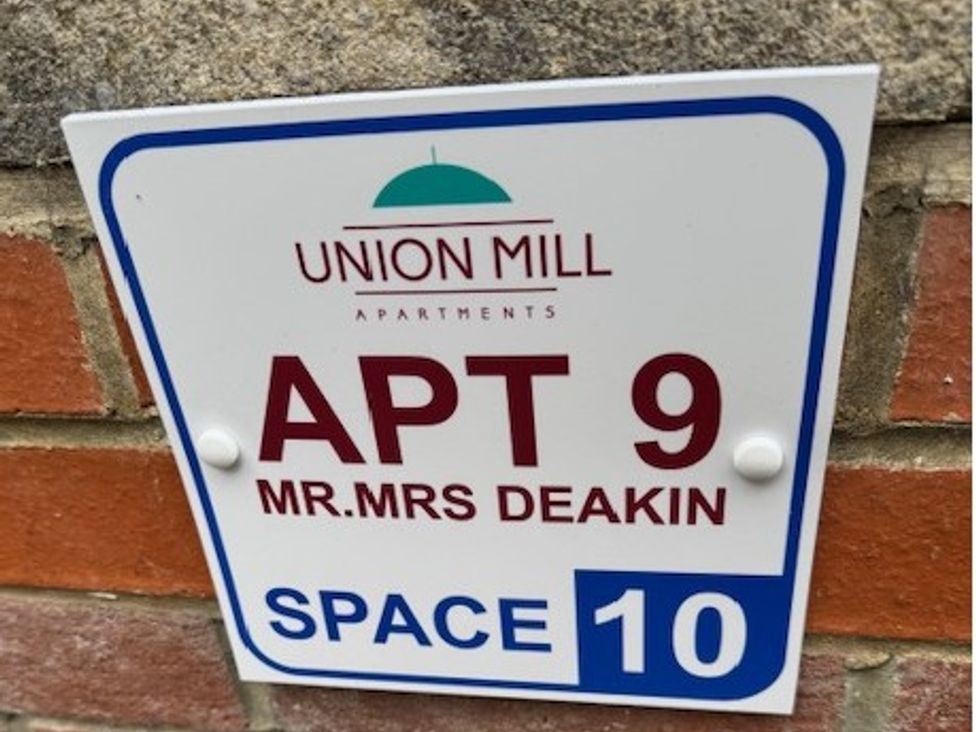 A sign for apartment 9 and space 10 at Union Mill Apartments in Whitby