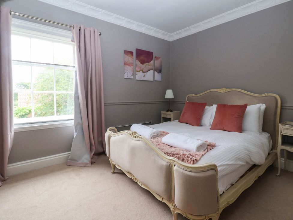 A bedroom with a bed and window at Kexby House