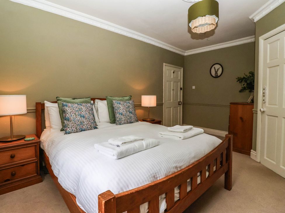 A bedroom with a bed and nightstands at Kexby House