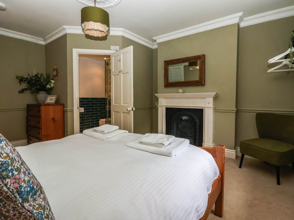 A bedroom with a bed and towels at Kexby House