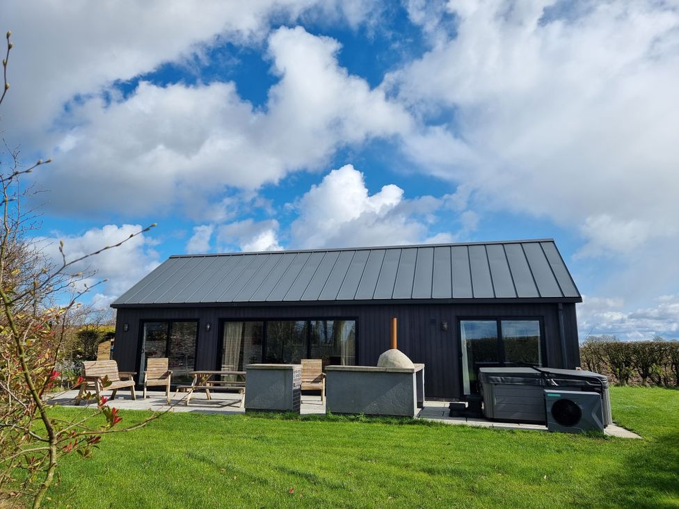 A house with a patio and chairs at Wren Huggate near Bishop Wilton