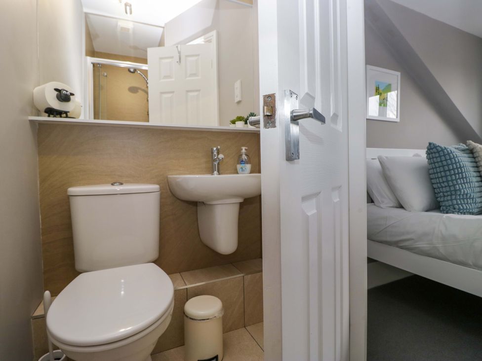 A bathroom with a toilet and sink at Beckmead in Windermere