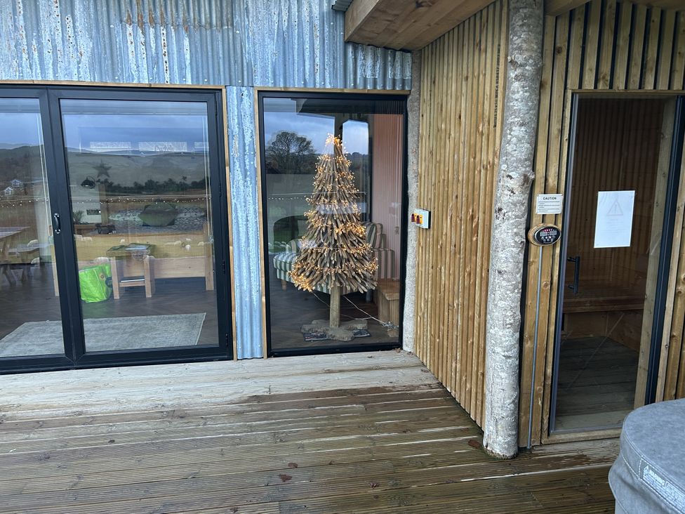 An outdoor area with a decorative tree and wooden structures at Bryn Hafod in Llandrindod Wells