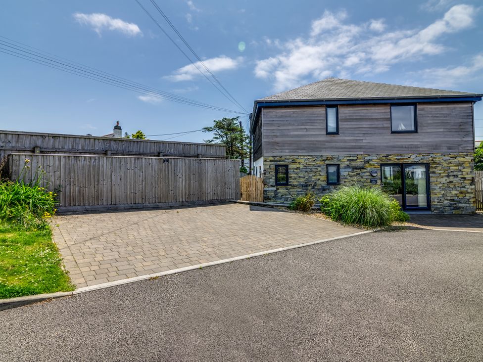 An outdoor area with a house and driveway at Sandy Cove, Praa Sands