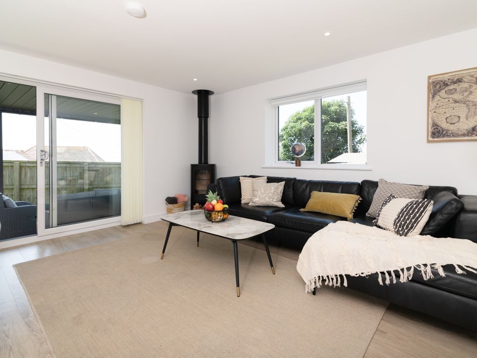 A living room with a sofa and coffee table at Sandy Cove in Praa Sands