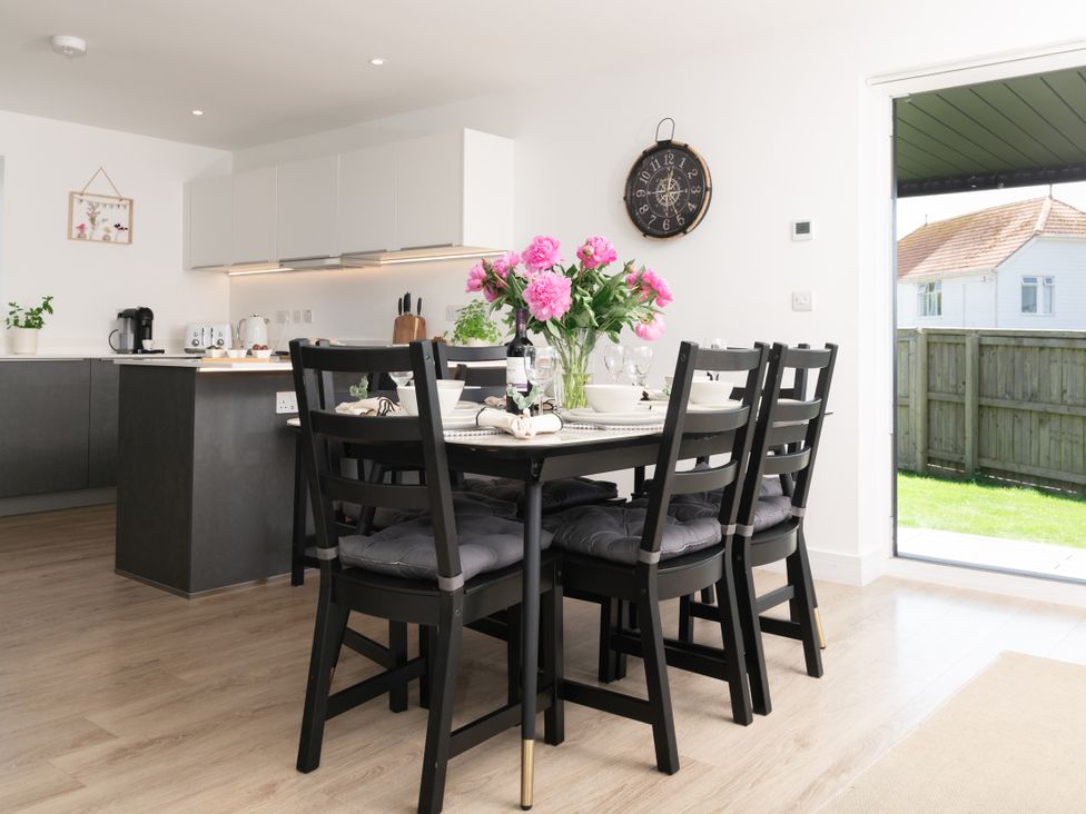 A kitchen with a dining table and chairs at Sandy Cove in Praa Sands