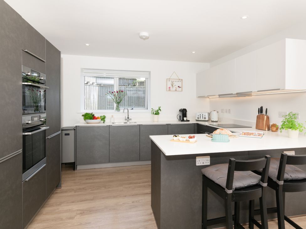 A kitchen with a sink and oven at Sandy Cove in Praa Sands