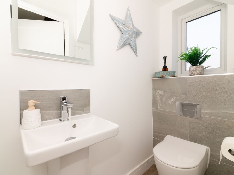 A bathroom with a sink and toilet at Sandy Cove in Praa Sands