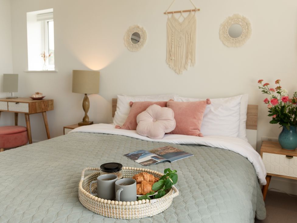A bedroom with a bed and decorative items at Sandy Cove in Praa Sands