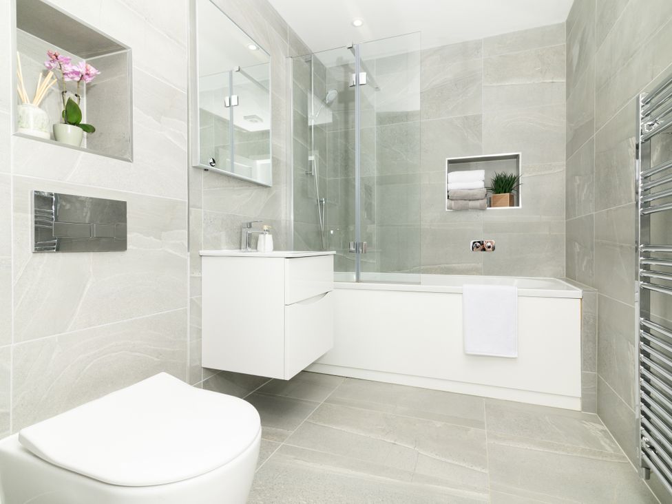 A bathroom with a bathtub, toilet, and vanity at Sandy Cove in Praa Sands