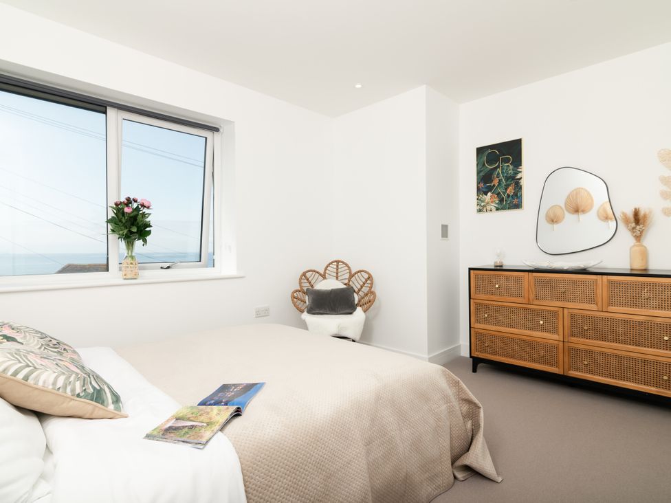 A bedroom with a bed and window at Sandy Cove in Praa Sands